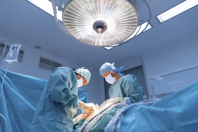 Surgeons performing surgery in operating Theater.